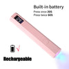 Pink handheld UV nail dryer lamp with a built-in battery and rechargeable feature.