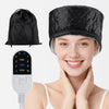 A woman smiling while wearing a black electric hair steamer cap and holding a white control device.