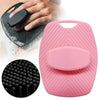 A pink silicone body scrubber with a rounded pad, shown next to a hand and a close-up of the textured surface.