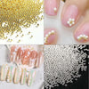 Close-up of gold and silver mixed stainless steel bead nail art decorations for manicures