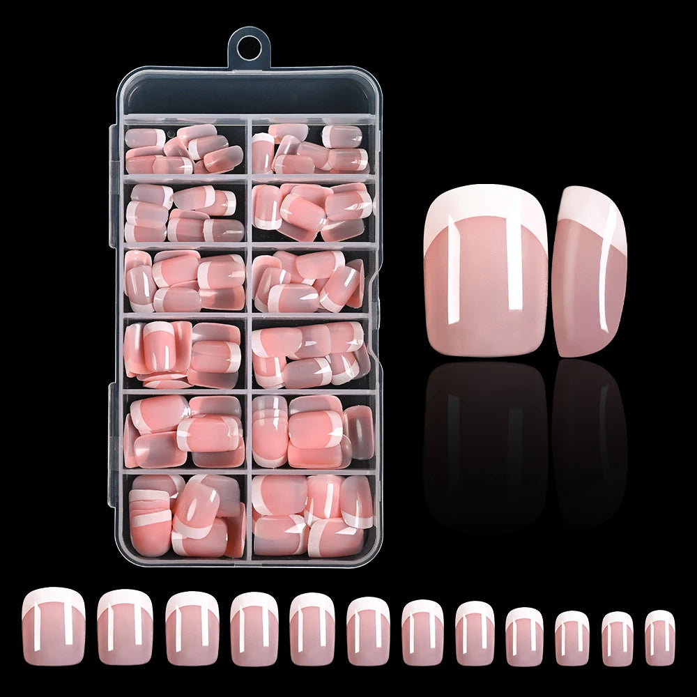 A clear plastic container holds a set of nude pink press-on nails with white French tips, displayed next to individual nails.