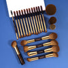 A collection of professional makeup brushes including various sizes and shapes for foundation and eyeshadow application.