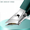 Silver ergonomic beveled nail clippers with a dark green handle resting on a light blue surface.