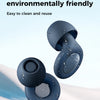 A close-up of blue silicone ear plugs floating in clear water against a snowy background.