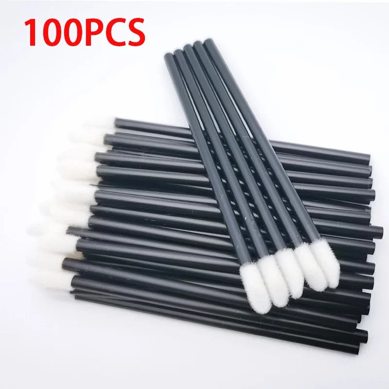 A set of 100 precision makeup brushes with black handles and white bristles arranged in a row.