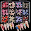 A clear plastic case holds a set of 3D floral butterfly pearl nail art charms in various colors and designs.