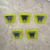 Four yellow plastic holders for a precision electric beard trimmer with black attachments.