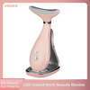 A pink LED-based neck beauty device with a silver base and curved applicator shown in a studio setting.