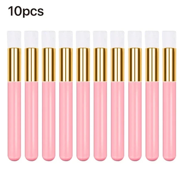 A set of ten pink and gold eyelash extension cleaning brushes with nylon bristles.