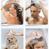 A woman is using a scalp massager brush to apply shampoo to her hair while relaxing in a bathtub.