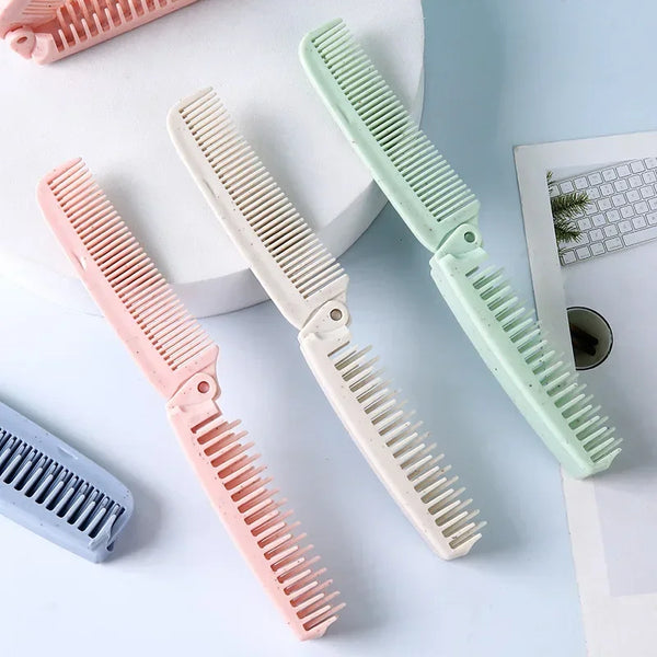 Three pink and mint green portable folding hairbrushes displayed on a white surface.