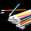 A collection of disposable lip brushes with nylon applicator wands in various colors like orange, pink, and blue.
