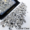Clear crystal rhinestones scattered on a black background for nail art and DIY crafts