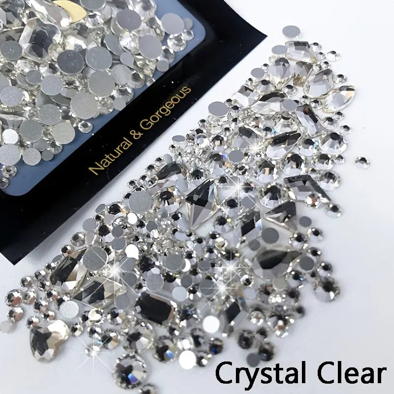 Clear crystal rhinestones scattered on a black background for nail art and DIY crafts