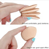 A hand holds a stack of soft, beige makeup sponge puffs with light blue tips, demonstrating their texture and use.