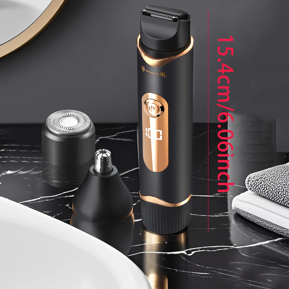 A black electric body hair trimmer with a gold accent is shown next to its detachable head and on a marble surface.