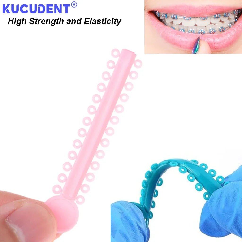 Pink orthodontic elastic ligature ties being applied to a tooth using a blue tool.