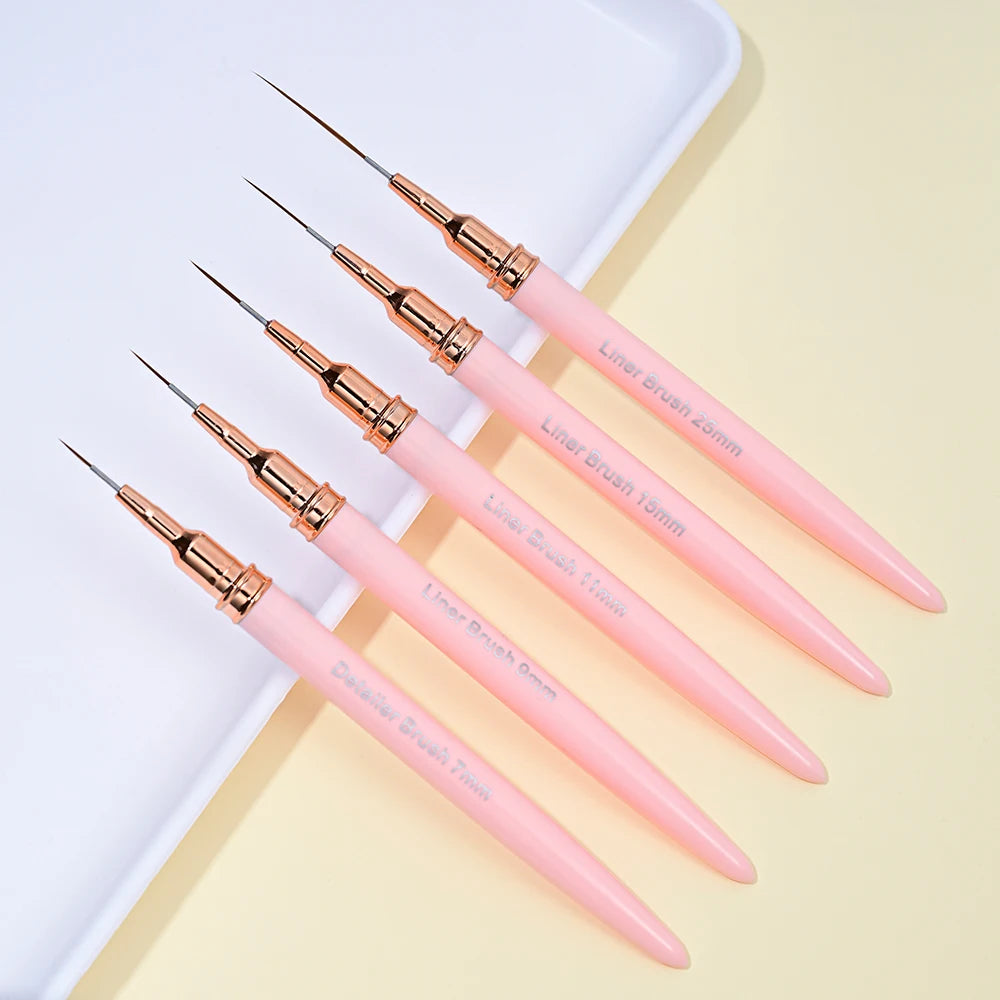 A set of pink nail art liner brushes with ultra-fine tips arranged on a white surface.