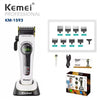 A white Kemei professional cordless hair clipper and trimmer set with various attachments shown on a black base.