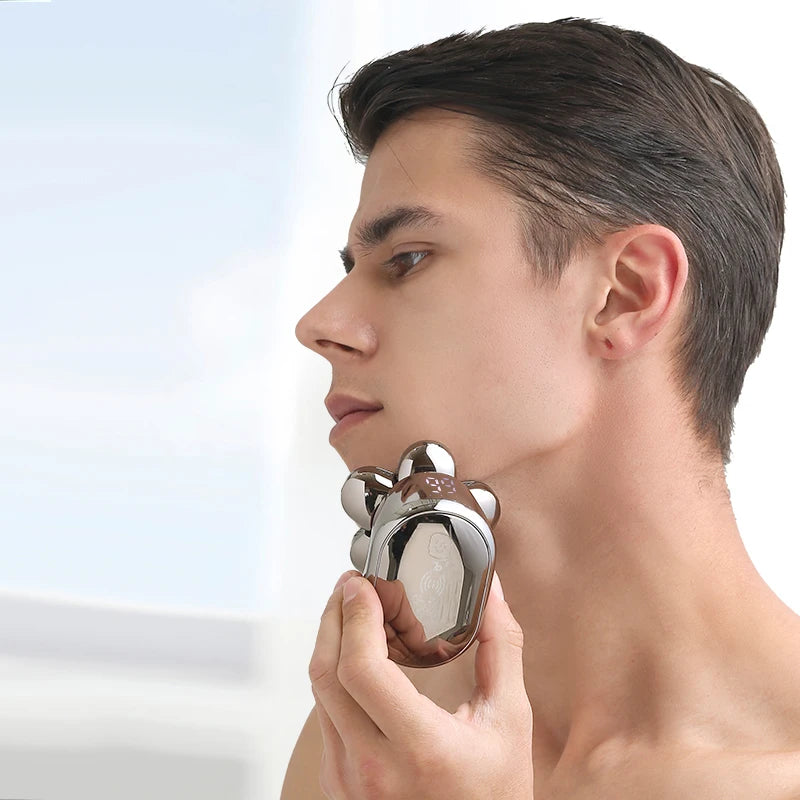 A hand is holding a chrome electric shaver near the jawline of a man, demonstrating its use.