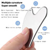 A hand holds a smooth, silver-colored Gua Sha tool with an irregular shape, demonstrating its use for facial massage.