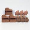 A set of twelve makeup sponges in various shades of nude and terracotta, packaged in white foam.