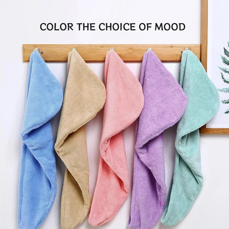 A collection of colorful microfiber hair towels wrapped and displayed on a wooden rack.