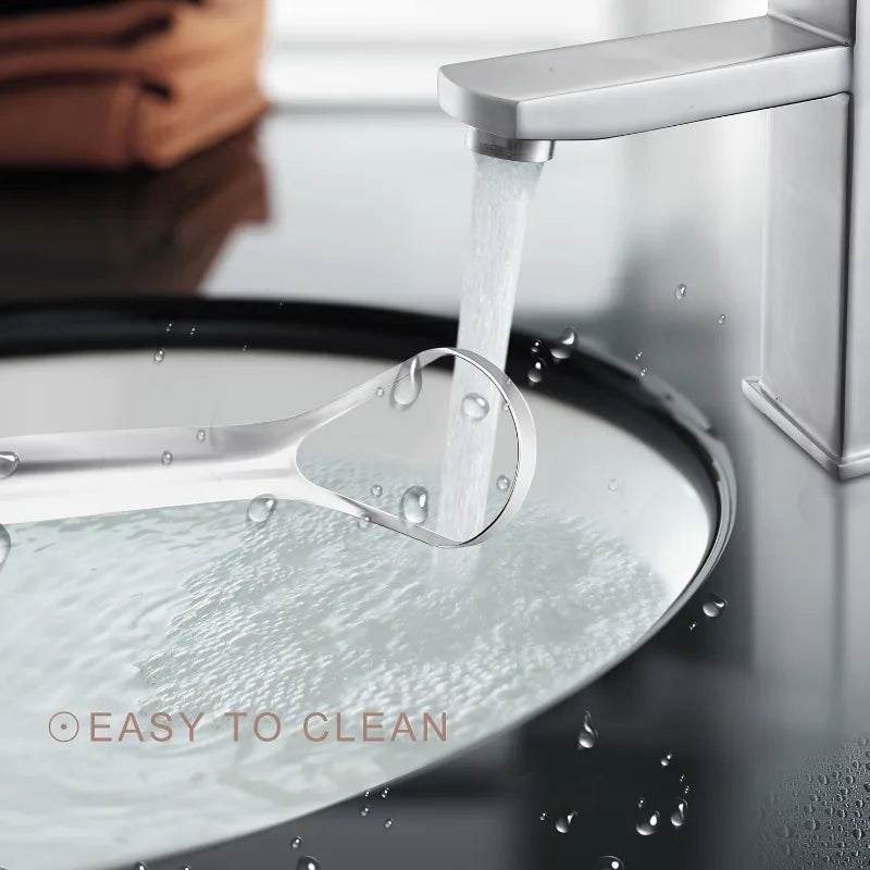 A portable stainless steel tongue scraper is shown scraping food from a plate under running water.