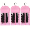A set of three pink plastic wig storage containers with metal hangers, each holding a black wig.