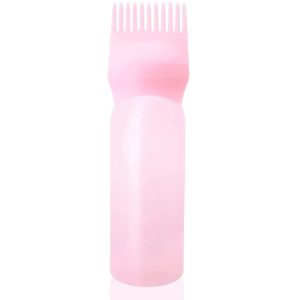 A pink bottle containing a hair color applicator comb with fine teeth.