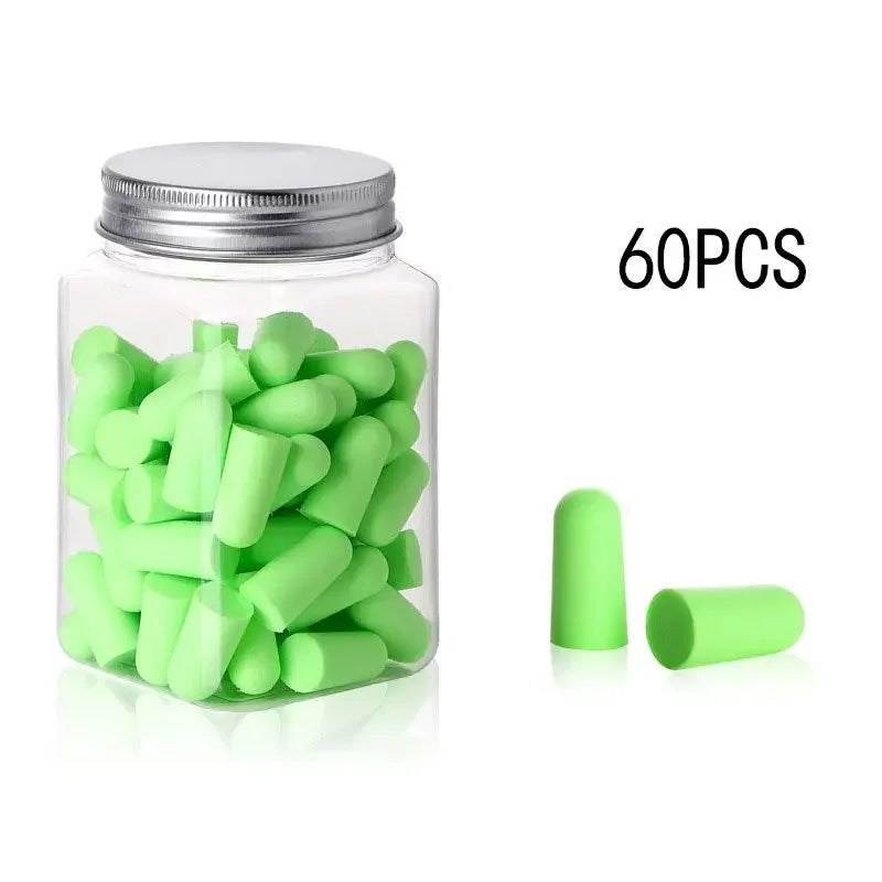 A clear jar filled with green memory foam earplugs and several loose green earplugs.
