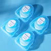 Three small blue plastic containers of mint dental floss are displayed on a light blue surface.