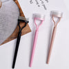 A set of pink and black precision metal eyelash separator and curler tools displayed on a white background.