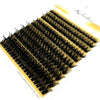A fan-shaped cluster of black mink eyelashes displayed on a yellow background.