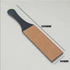 A black leather sharpening strop with a tan pad, shown diagonally on a light gray background.