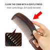 A hand is gently pressing the inner comb design of a brown hair comb to extrude dirt.
