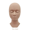 A realistic silicone mannequin head used for eyelash extension practice.
