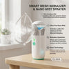 A white portable smart mesh nebulizer with a clear chamber is shown on a wooden table.