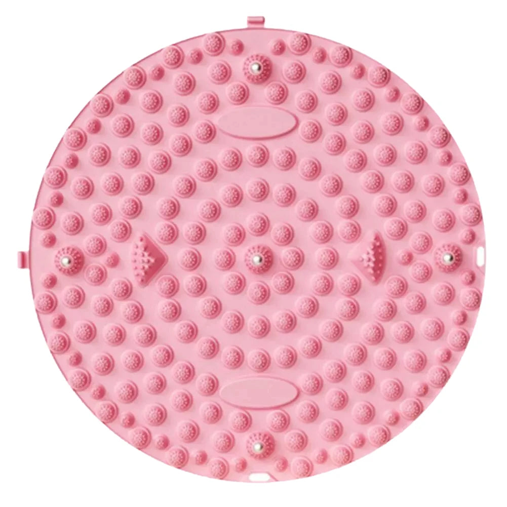 A pink magnetic foot massage mat with numerous raised silicone bumps for relaxation.