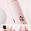 A pink double-head electric epilator device shown in a close-up view with surrounding white objects.