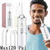 A man is holding a portable oral irrigator device with a clear tube and nozzle, demonstrating its use.