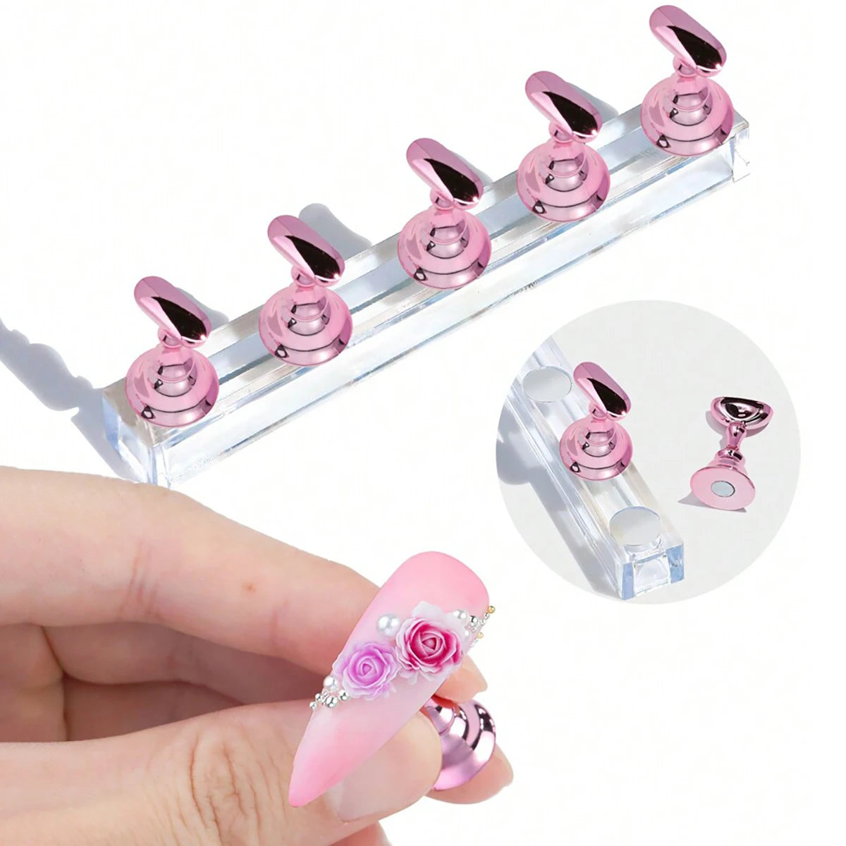 A set of pink magnetic nail art display stands and a pink acrylic nail is shown on a hand.