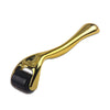 A gold-colored titanium micro derma roller tool with a textured black head.