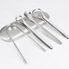 A set of three stainless steel tongue scrapers for oral hygiene placed on a light gray tray.