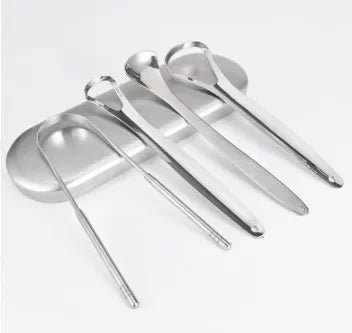 A set of three stainless steel tongue scrapers for oral hygiene placed on a light gray tray.