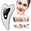A white microcurrent facial massager device shown next to a woman demonstrating its use on her face.