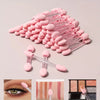 A collection of pink double-sided nail art brushes with sponge applicators arranged on a light background.