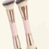 A pair of precision double-ended makeup foundation brushes with pink and rose gold accents.