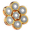 A cluster of eight precision electric razor blades with gold-colored housings and silver cutting discs.