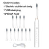 A white electric toothbrush set including the body, USB charging cable, and twelve brush heads.